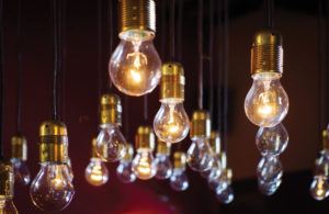 Light bulbs hanging from the ceiling over red wall