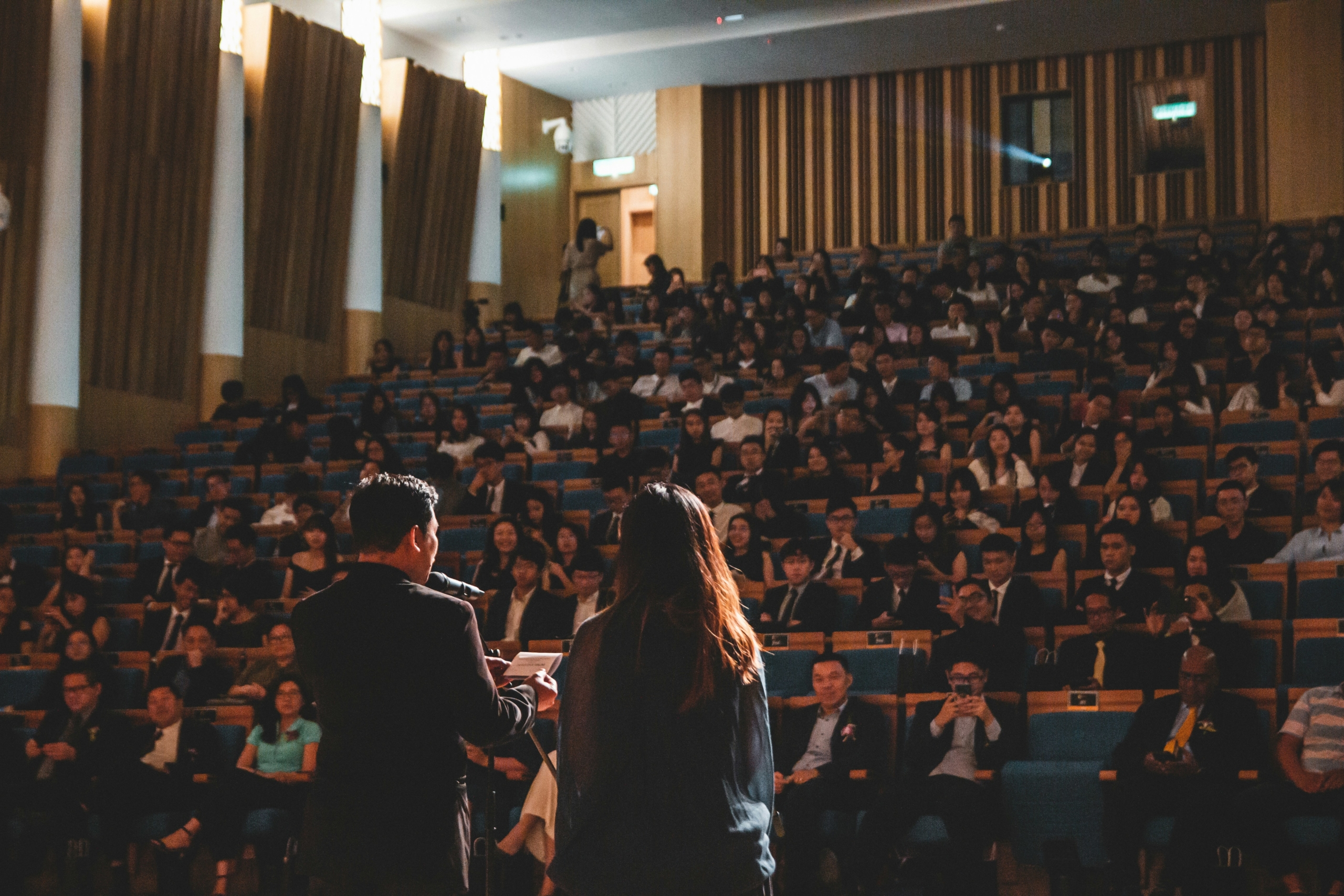 CEOs speaking before audience. Photo by Wan San Yip on Unsplash.
